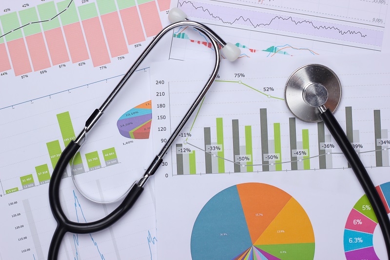Medical statistics and analytics. Stethoscope with graphs and charts.